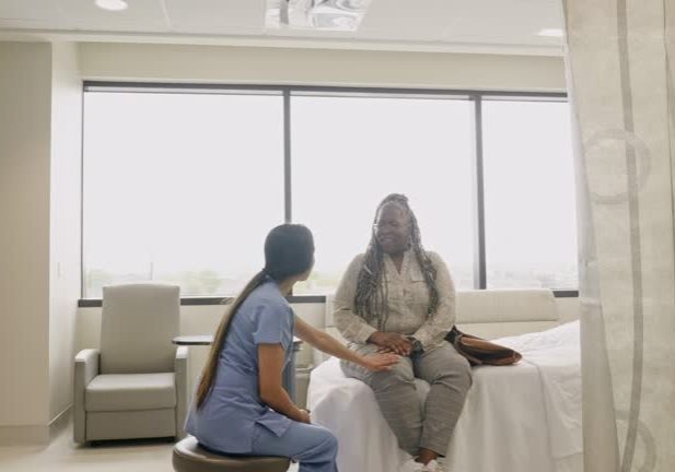 In the emergency room, the mid adult female nurse practitioner sits as she explains the test results to the mature adult woman sitting on the gurney.
